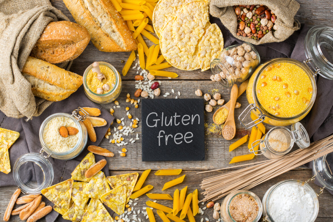 Healthy eating, dieting, balanced food concept. Assortment of gluten free food and flour, almond, corn, rice on a wooden table. Top view flat lay background